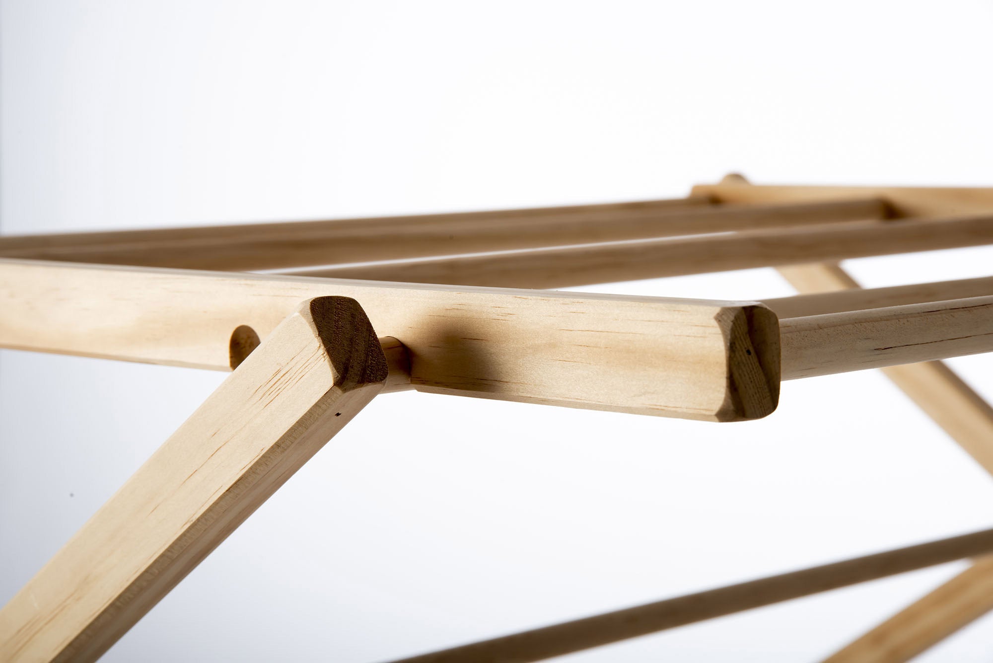 Close-up of a wooden drying rack on a white background. Victoria James Home Eco Deluxe Clothes Airer