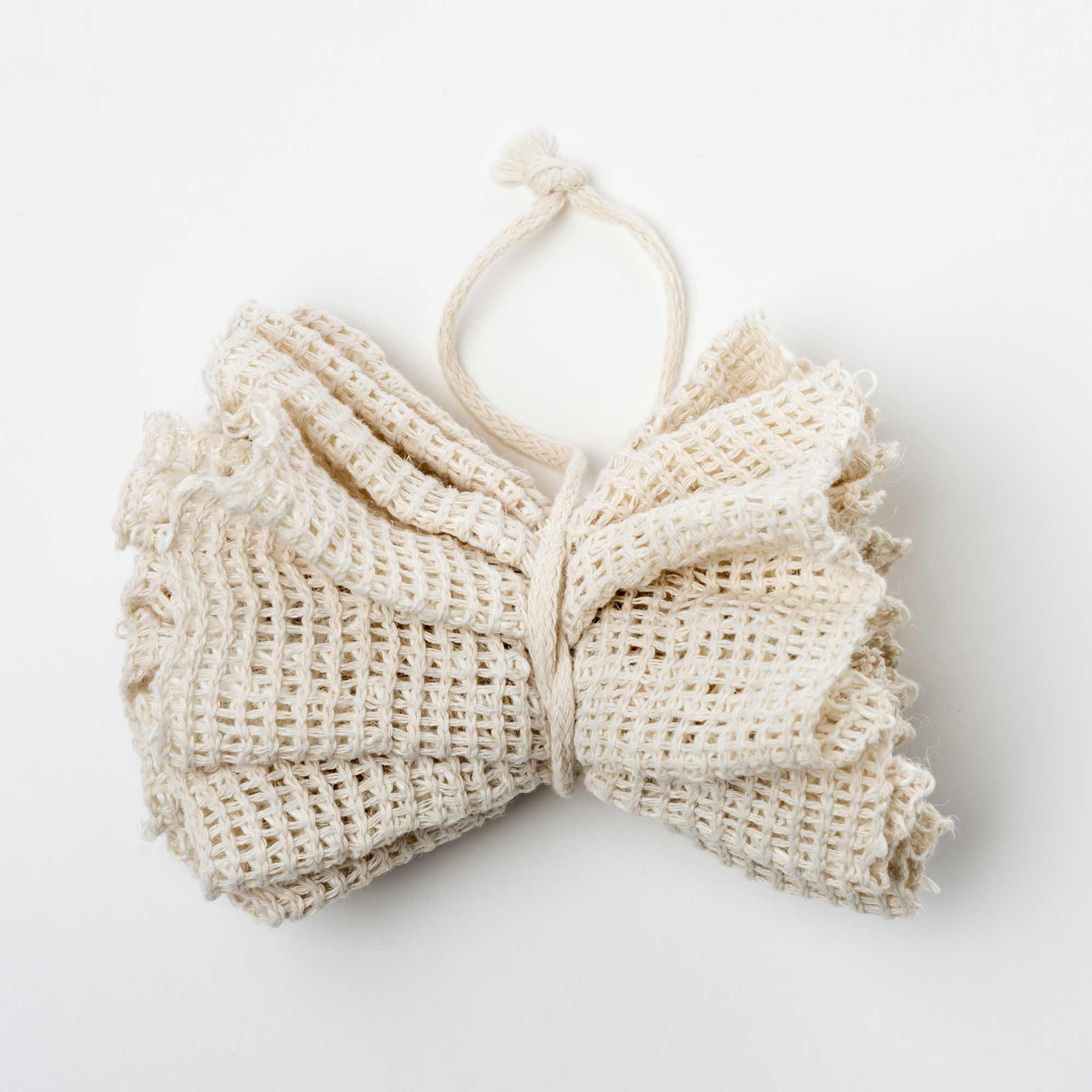 Beige woven headband on a white background.Victoria James Body Ramie Bath Puff