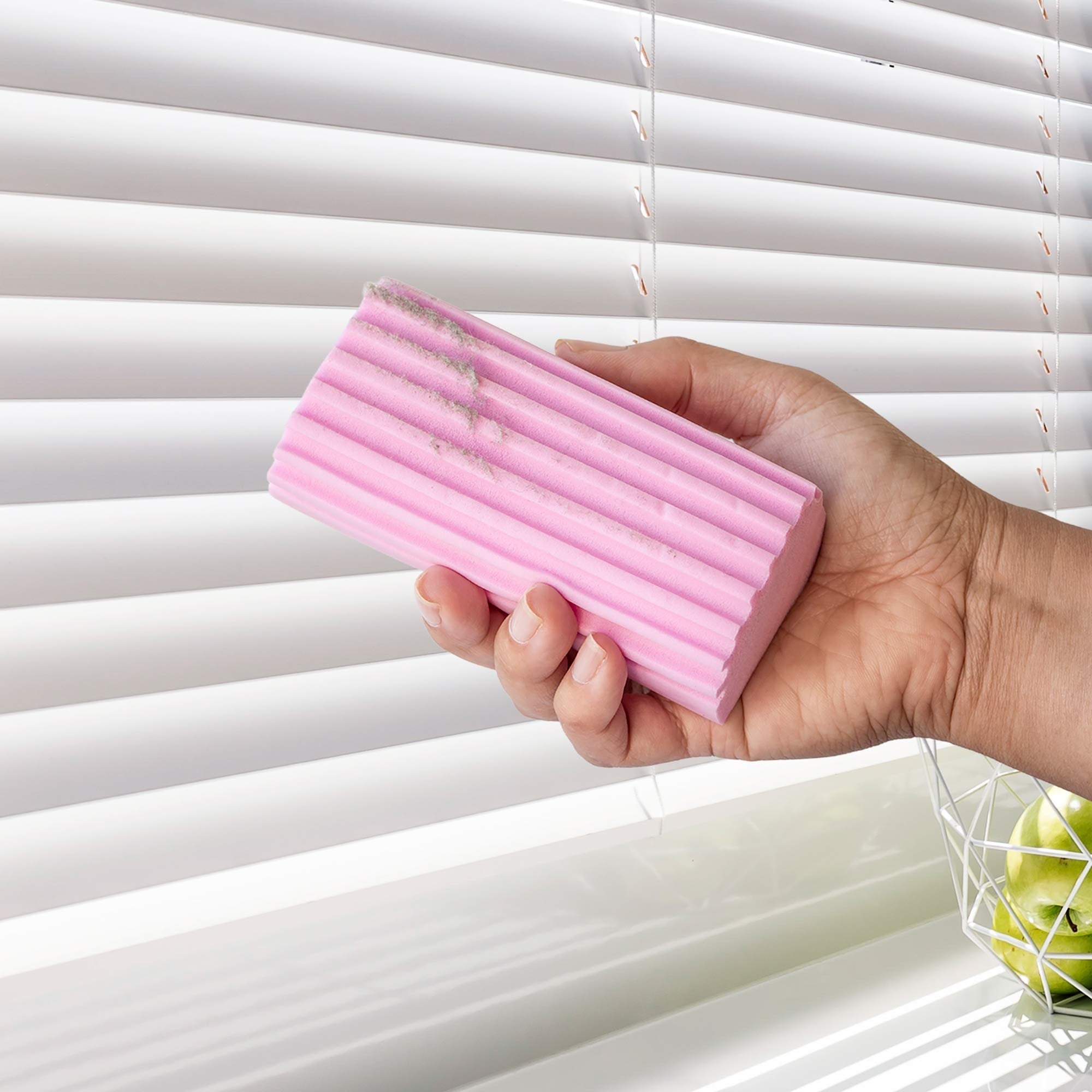 Hand holding a pink cleaning tool in front of white blinds Simply Clean Damp Duster Sponge - 2 Pack
