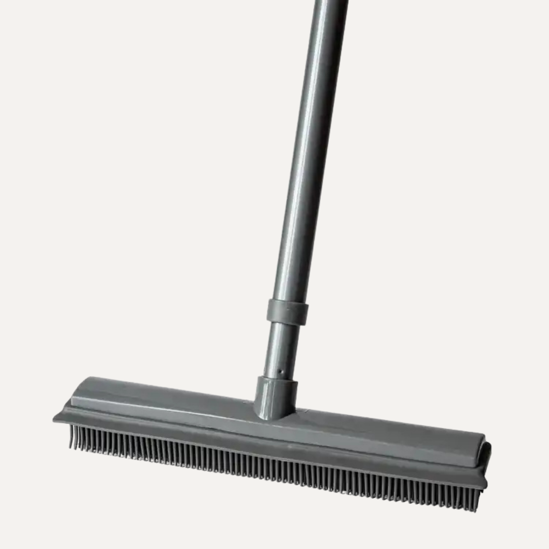 Gray broom with a wide brush head on a white background. Simply Clean Rubber Broom with Telescopic Handle